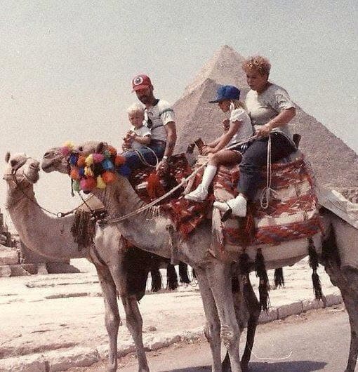 Kate as a child riding on a camel